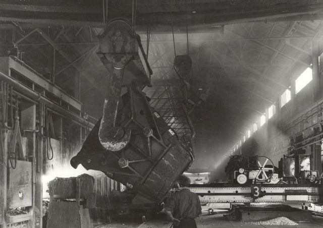 Molten iron from Blast Furnace being charged into Open Hearth Furnace. Approx 1937.